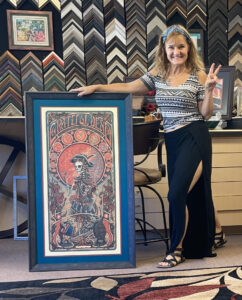 Woman stands next to Grateful Dead image